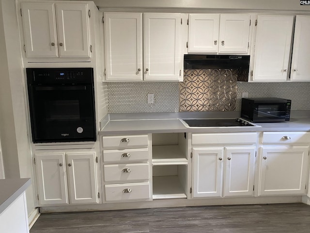361 Hickory Hill Dr, Columbia, SC 29210 - kitchen with black appliances, white cabinets, under cabinet range hood, and wood finished floors