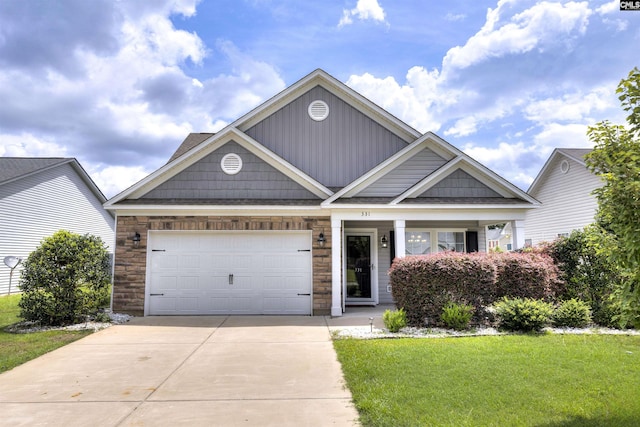 331 Aberlour Dr, Sumter, SC 29154 - view of front of house featuring concrete driveway, stone siding, a front lawn, and a garage