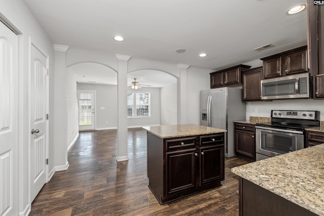 331 Aberlour Dr, Sumter, SC 29154 - kitchen featuring stainless steel appliances, arched walkways, dark wood-style floors, dark brown cabinets, and recessed lighting