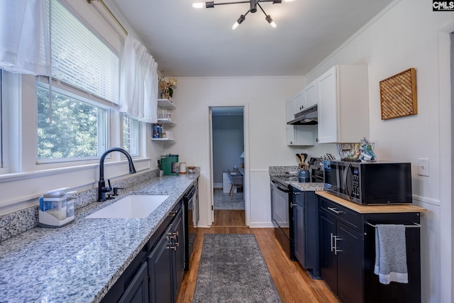 39 Downing, Columbia, SC 29209 - kitchen featuring black appliances, under cabinet range hood, light wood finished floors, open shelves, and white cabinetry