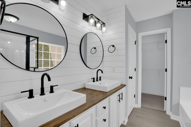 127 Waterville Dr, Columbia, SC 29229 - full bathroom with wood finished floors, double vanity, a spacious closet, and a tub to relax in