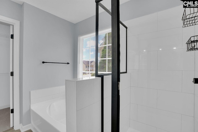 127 Waterville Dr, Columbia, SC 29229 - bathroom featuring a garden tub, tiled shower, and a spacious closet