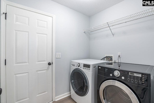 127 Waterville Dr, Columbia, SC 29229 - laundry room featuring washer and clothes dryer and a textured ceiling
