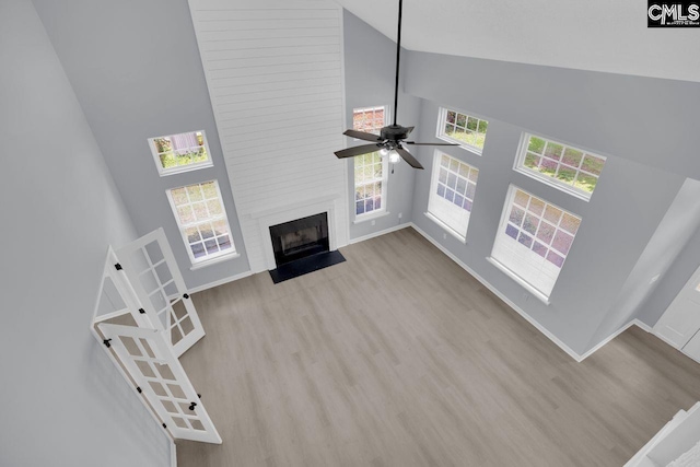 127 Waterville Dr, Columbia, SC 29229 - unfurnished living room featuring high vaulted ceiling, wood finished floors, a fireplace, and ceiling fan