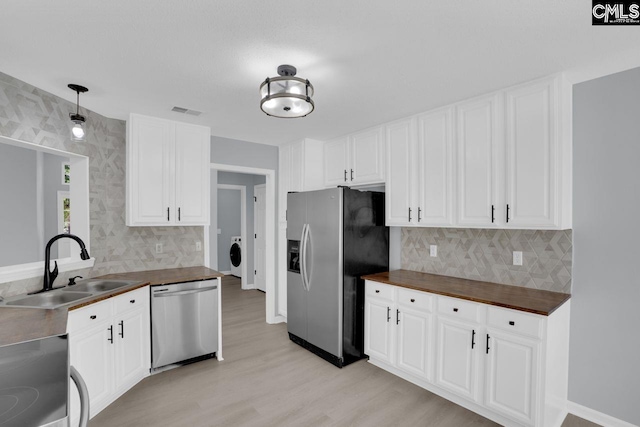 127 Waterville Dr, Columbia, SC 29229 - kitchen with stainless steel appliances, wood counters, light wood-type flooring, and decorative backsplash