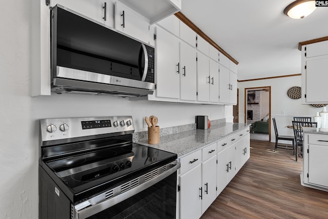 301 Colony Hill Rd, Lexington, SC 29072 - kitchen featuring stainless steel range with electric stovetop, white cabinets, dark wood finished floors, light stone countertops, and ornamental molding