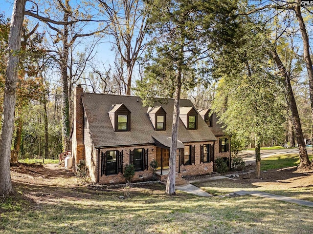 301 Colony Hill Rd, Lexington, SC 29072 - cape cod-style house with brick siding, a chimney, a front yard, and roof with shingles