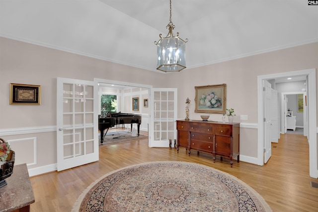 8 Sand Spur Rd, Columbia, SC 29223 - hall featuring french doors, light wood-type flooring, a chandelier, and ornamental molding