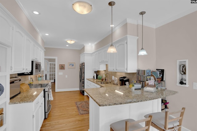 8 Sand Spur Rd, Columbia, SC 29223 - kitchen with stainless steel appliances, a peninsula, a kitchen breakfast bar, white cabinetry, and ornamental molding
