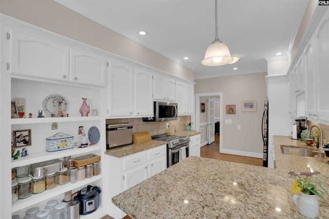 8 Sand Spur Rd, Columbia, SC 29223 - kitchen featuring appliances with stainless steel finishes, white cabinets, backsplash, recessed lighting, and crown molding