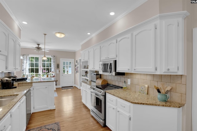8 Sand Spur Rd, Columbia, SC 29223 - kitchen featuring appliances with stainless steel finishes, white cabinets, ceiling fan, decorative backsplash, and a peninsula