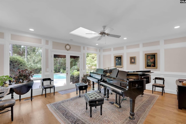 8 Sand Spur Rd, Columbia, SC 29223 - living area with a ceiling fan, a skylight, a decorative wall, light wood-style flooring, and french doors