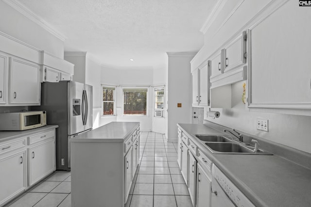 705 Kinlock Ct, Columbia, SC 29223 - kitchen with white microwave, a center island, ornamental molding, light tile patterned flooring, and white cabinetry