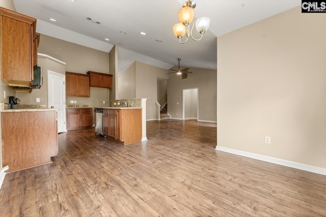 422 Drooping Leaf Rd, Lexington, SC 29072 - kitchen featuring open floor plan, brown cabinetry, wood finished floors, light stone counters, and a ceiling fan
