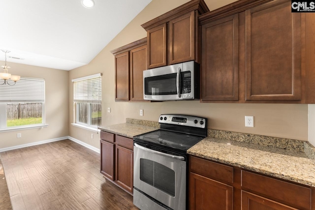 422 Drooping Leaf Rd, Lexington, SC 29072 - kitchen with stainless steel appliances, lofted ceiling, dark wood-style floors, a chandelier, and light stone countertops