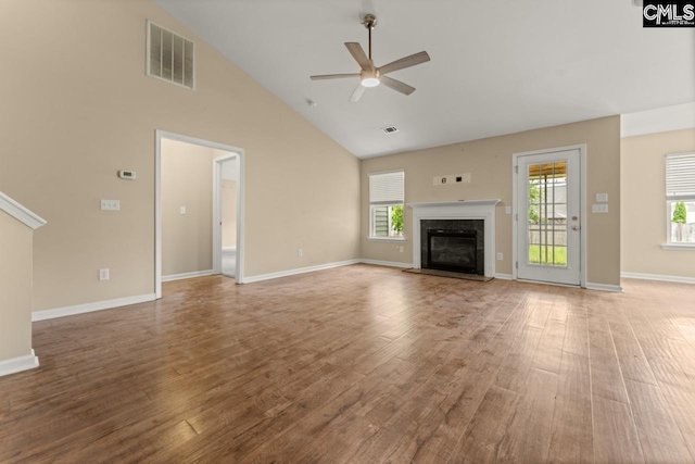 422 Drooping Leaf Rd, Lexington, SC 29072 - unfurnished living room with ceiling fan, high vaulted ceiling, wood finished floors, and a glass covered fireplace