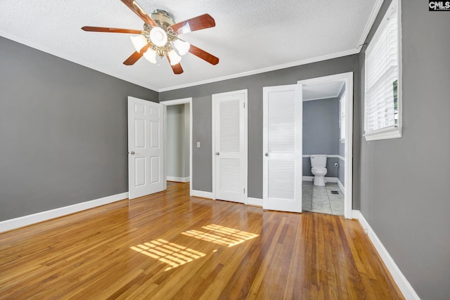 159 Rogers Rd, Saluda, SC 29138 - unfurnished bedroom with wood finished floors, a textured ceiling, crown molding, connected bathroom, and ceiling fan