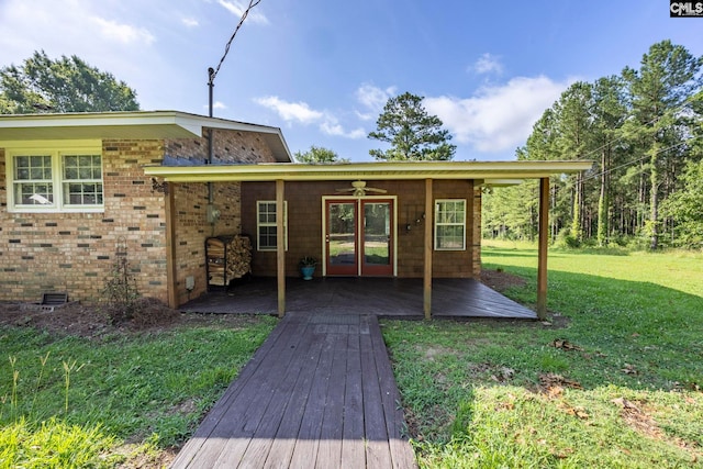 159 Rogers Rd, Saluda, SC 29138 - rear view of property featuring a lawn, a ceiling fan, french doors, brick siding, and a wooden deck