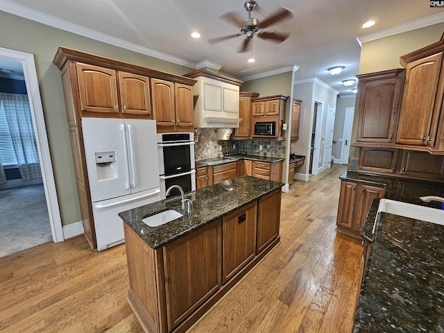 116 Avington Ln, Columbia, SC 29229 - kitchen with white fridge with ice dispenser, stainless steel double oven, built in microwave, ceiling fan, and an island with sink