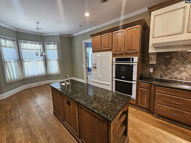 116 Avington Ln, Columbia, SC 29229 - kitchen featuring stainless steel double oven, white refrigerator with ice dispenser, light wood-type flooring, decorative backsplash, and recessed lighting