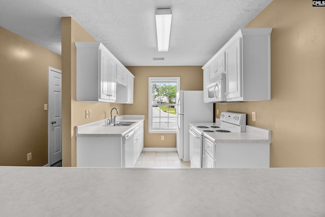 364 Elders Pond Cir, Columbia, SC 29229 - kitchen featuring white appliances, light countertops, light tile patterned flooring, white cabinetry, and a textured ceiling
