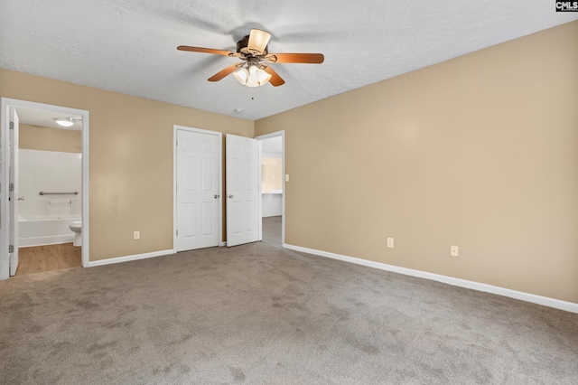 364 Elders Pond Cir, Columbia, SC 29229 - unfurnished bedroom featuring carpet flooring, connected bathroom, a textured ceiling, and ceiling fan