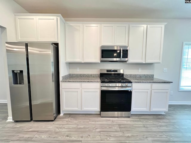 1958 Castlerock Dr, Sumter, SC 29153 - kitchen featuring stainless steel appliances, white cabinets, light stone counters, and light wood finished floors