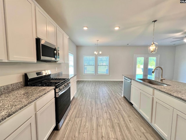 1958 Castlerock Dr, Sumter, SC 29153 - kitchen featuring stainless steel appliances, plenty of natural light, light wood-type flooring, white cabinets, and recessed lighting