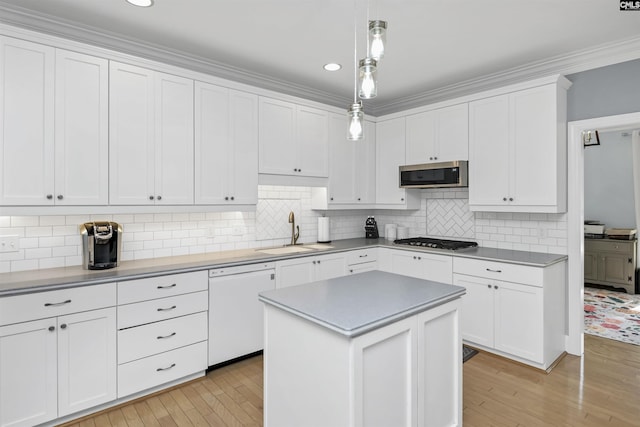 430 Hampton Creek Ct, Columbia, SC 29209 - kitchen with appliances with stainless steel finishes, light wood finished floors, white cabinets, pendant lighting, and backsplash