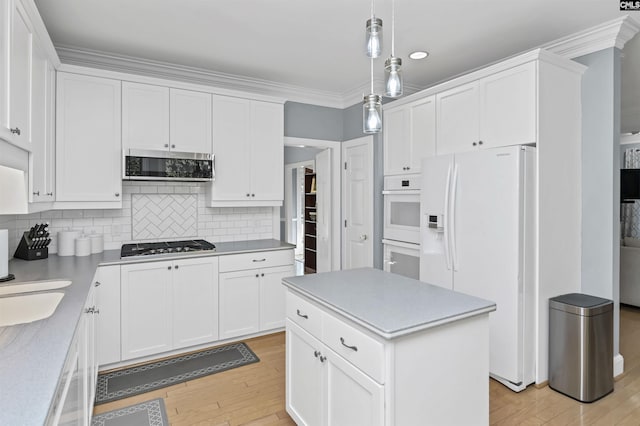 430 Hampton Creek Ct, Columbia, SC 29209 - kitchen with stainless steel appliances, light wood finished floors, white cabinets, light countertops, and crown molding