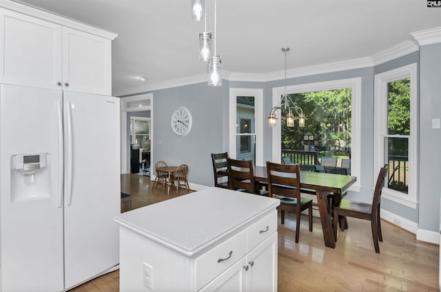430 Hampton Creek Ct, Columbia, SC 29209 - kitchen with freestanding refrigerator, light wood-style floors, ornamental molding, hanging light fixtures, and a kitchen island