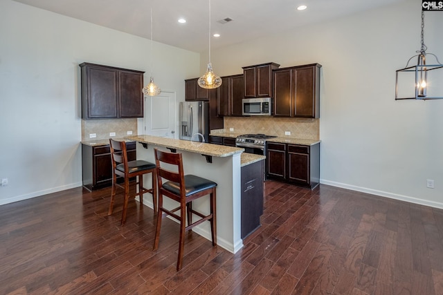22 Kentucky Derby Ct, Lugoff, SC 29078 - kitchen with stainless steel appliances, dark wood-style floors, dark brown cabinets, backsplash, and recessed lighting