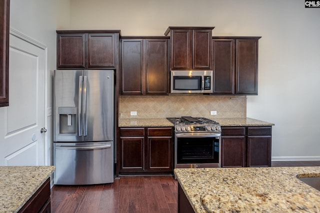 22 Kentucky Derby Ct, Lugoff, SC 29078 - kitchen with appliances with stainless steel finishes, decorative backsplash, light stone counters, and dark brown cabinetry