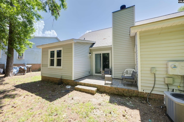 241 Friarsgate Blvd, Irmo, SC 29063 - back of property featuring a patio area, a chimney, and a shingled roof