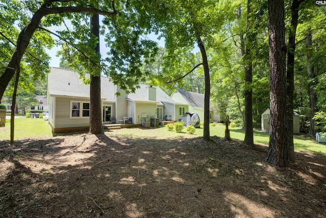 241 Friarsgate Blvd, Irmo, SC 29063 - rear view of house featuring a storage unit and a yard