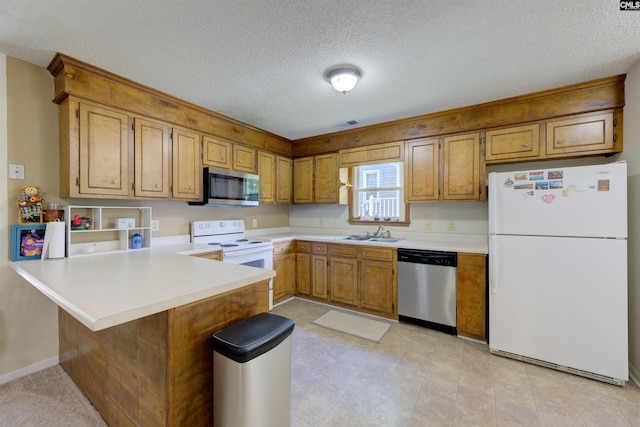 241 Friarsgate Blvd, Irmo, SC 29063 - kitchen featuring stainless steel appliances, a peninsula, brown cabinets, a textured ceiling, and light countertops