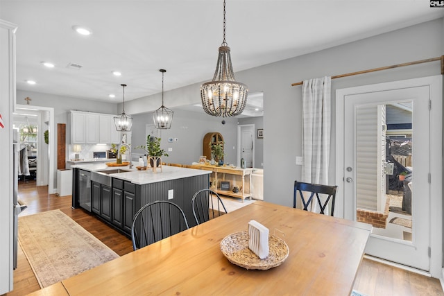 214 Chapin Brook Ct, Chapin, SC 29036 - dining area featuring recessed lighting, a chandelier, wood finished floors, and wine cooler