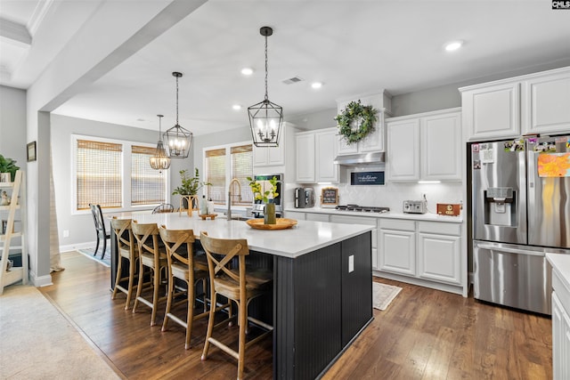 214 Chapin Brook Ct, Chapin, SC 29036 - kitchen with stainless steel appliances, an island with sink, dark wood-type flooring, light countertops, and white cabinets
