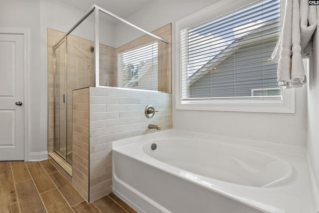 214 Chapin Brook Ct, Chapin, SC 29036 - full bath featuring a garden tub, a shower stall, and wood finish floors
