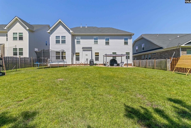 214 Chapin Brook Ct, Chapin, SC 29036 - rear view of house with a trampoline and a fenced backyard