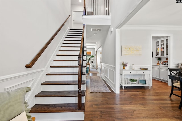 214 Chapin Brook Ct, Chapin, SC 29036 - staircase with a decorative wall, crown molding, wood finished floors, a wainscoted wall, and a towering ceiling
