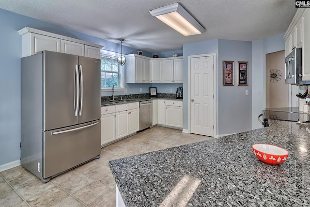 4 Beckworth Ct, Irmo, SC 29063 - kitchen with appliances with stainless steel finishes, white cabinetry, a textured ceiling, dark stone counters, and a peninsula