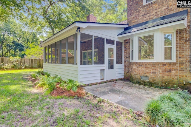 303 High Grove Rd, Summerville, SC 29485 - view of property exterior featuring a sunroom, a patio area, brick siding, and a chimney