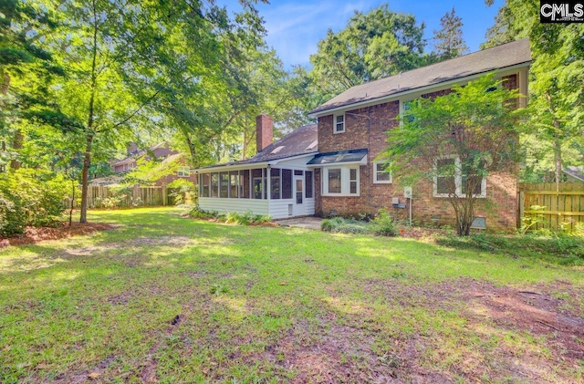 303 High Grove Rd, Summerville, SC 29485 - back of property with a sunroom, a chimney, and brick siding