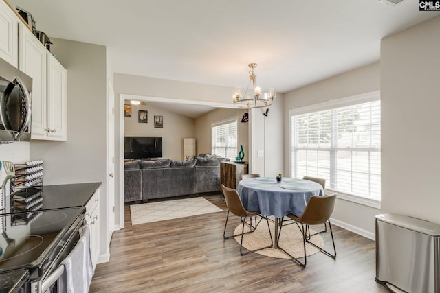 938 Farnsworth Dr, Hopkins, SC 29061 - dining area with light wood-style floors and a chandelier