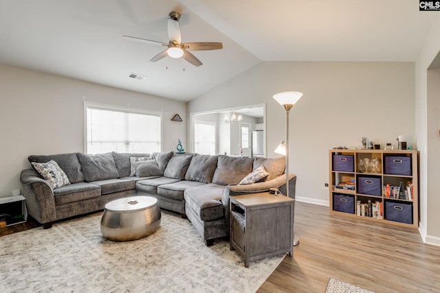 938 Farnsworth Dr, Hopkins, SC 29061 - living area featuring a ceiling fan, light wood finished floors, vaulted ceiling, and a chandelier