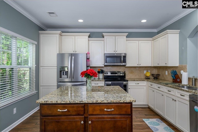 620 Blue Ledge Cir, Lexington, SC 29072 - kitchen with stainless steel appliances, decorative backsplash, light stone counters, and ornamental molding