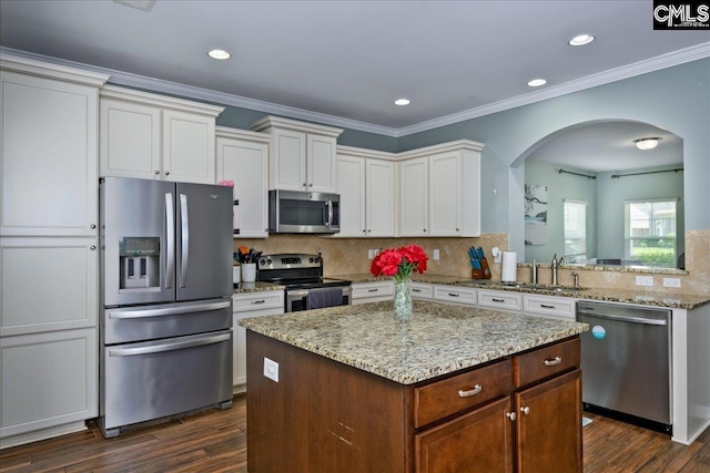 620 Blue Ledge Cir, Lexington, SC 29072 - kitchen with stainless steel appliances, arched walkways, dark wood finished floors, tasteful backsplash, and recessed lighting