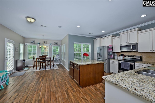 620 Blue Ledge Cir, Lexington, SC 29072 - kitchen featuring appliances with stainless steel finishes, dark wood-style flooring, decorative backsplash, crown molding, and white cabinets