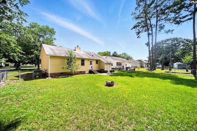 224 Ashton Cir, Lexington, SC 29073 - rear view of house with crawl space, a fenced backyard, an outdoor fire pit, and a chimney